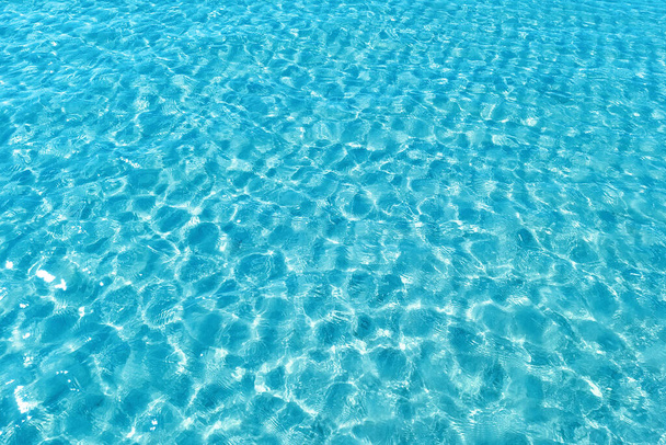 Background shot of aqua water surface. Swimming pool with sunny reflections. - Photo, Image