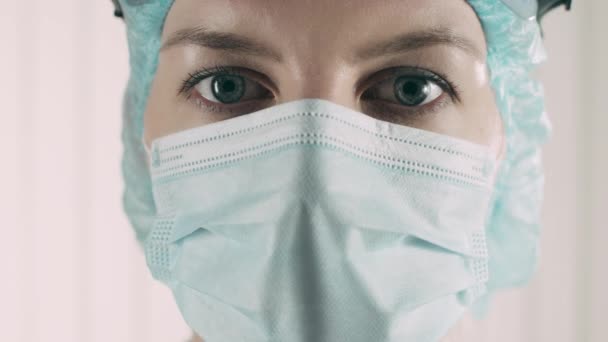 Qualified medical worker putting on protective goggles, tired female doctor - Materiał filmowy, wideo