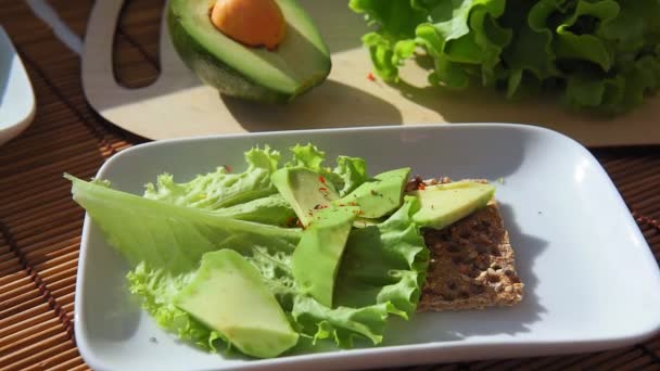 Healthy avocado toast for Breakfast, sliced avocado, salt and pepper. - Footage, Video
