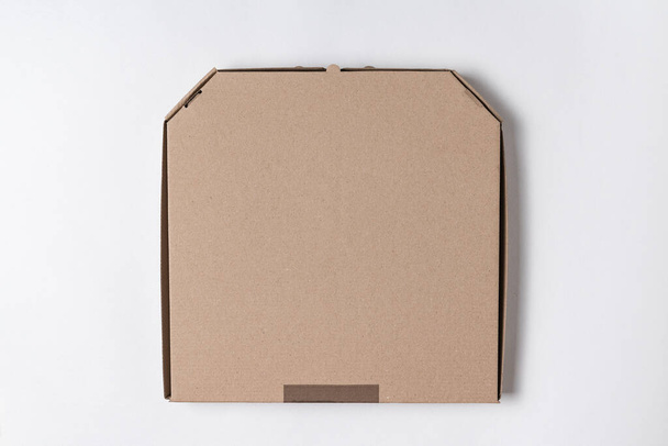 Cardboard pizza box on white background. Mockup, place for text - Valokuva, kuva