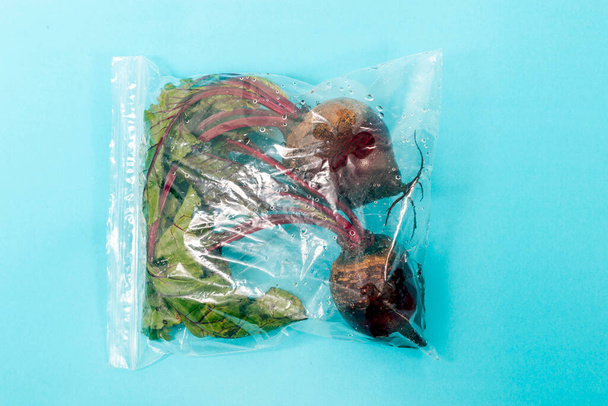 fresh organic vegetable roots from the grocery market on a plastic bag. - Fotografie, Obrázek