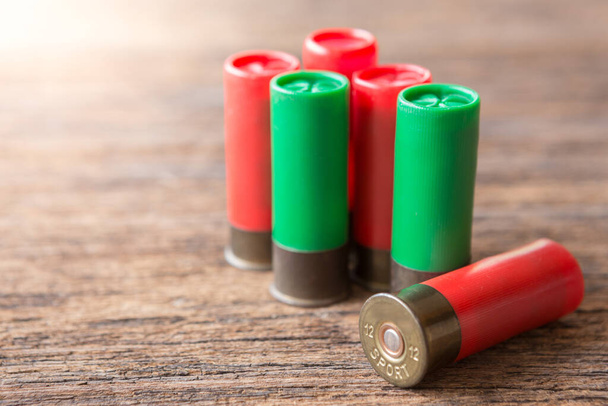 Selective focus of Many Bullet of Shotgun on wooden background with sunlight - Photo, Image