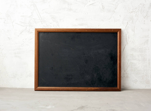 empty wooden rectangular frame, chalk board for writing a to-do list, menu on a white cement background. Back to school - Foto, Imagem