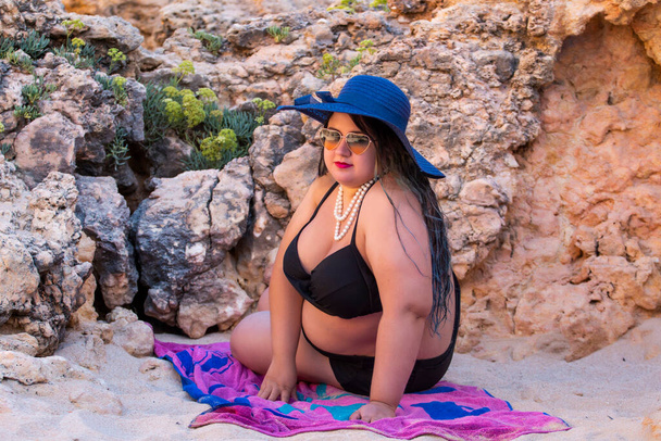 beautiful sensual woman with black bikini and dark shades on the beach. - Photo, Image