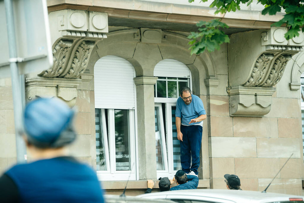 Man on the window trying to repair the window - Fotografie, Obrázek