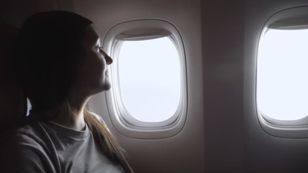 lady looks at watch to know time in passenger cabin closeup - Footage, Video