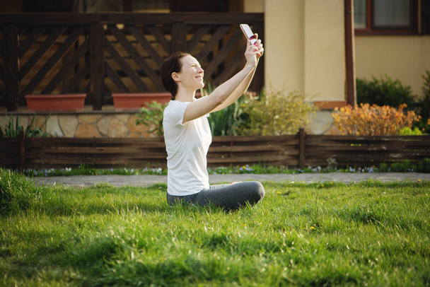 Smiling young woman making selfie. - Valokuva, kuva