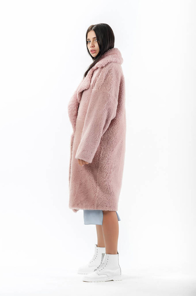 girl in a fur coat on a white background for a catalog - Photo, image