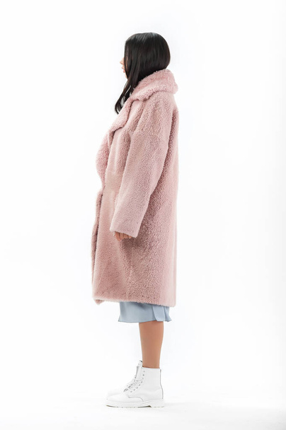 girl in a fur coat on a white background for a catalog - Foto, Imagem