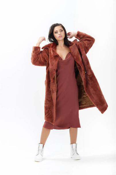 girl in a fur coat on a white background for a catalog - Foto, imagen