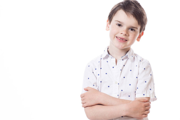 Young cute happy little boy posing on white background.  - Foto, afbeelding