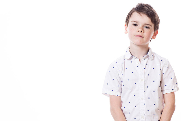 Young cute happy little boy posing on white background.  - Foto, immagini