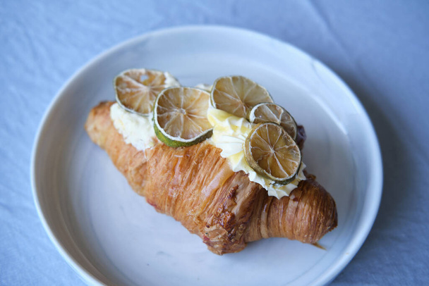 croissant with creme patisserie and lemon - Photo, Image