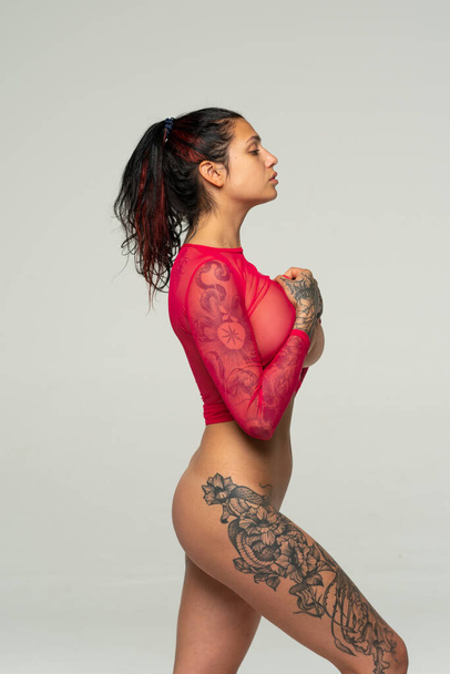 young beautiful girl posing in red lingerie in a studio - Foto, immagini