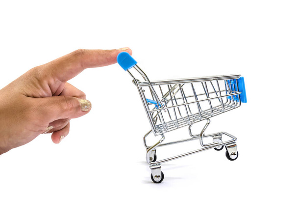 hand pushing a small shopping cart on a white background - Фото, зображення