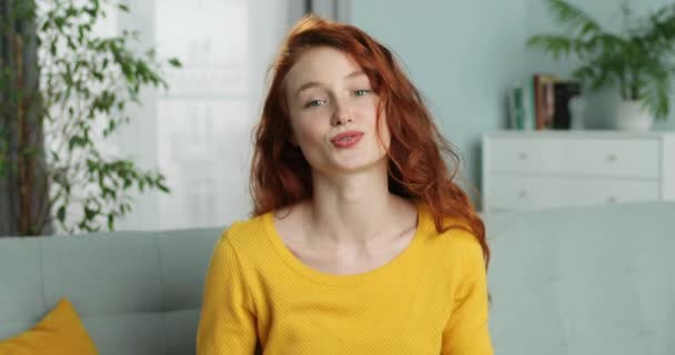 Cheerful pretty young Caucasian woman blogger talking to camera and telling something from home. Self-isolation lockdown concept. Beautiful internet coach having videoblog. Vlog concept. Coaching. - Metraje, vídeo