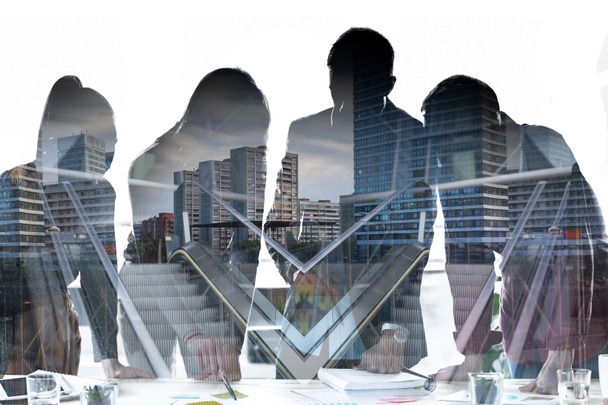 Double exposure of silhouette of business team talking in the meeting on coworking space over city life background. - Photo, Image