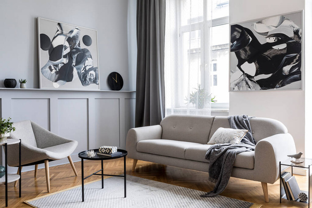 Modern scandinavian home interior of living room with design gray sofa, armchair, marble stool, black coffee table, stylish paintings, decoration and elegant personal accessories in home decor. - Valokuva, kuva