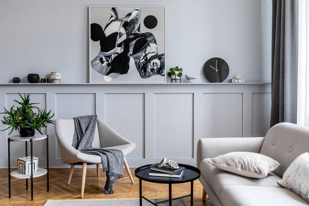 Stylish scandinavian home interior of living room with design gray sofa, armchair, marble stool, black coffee table, modern paintings, decoration, plant and elegant personal accessories in home decor. - Фото, зображення