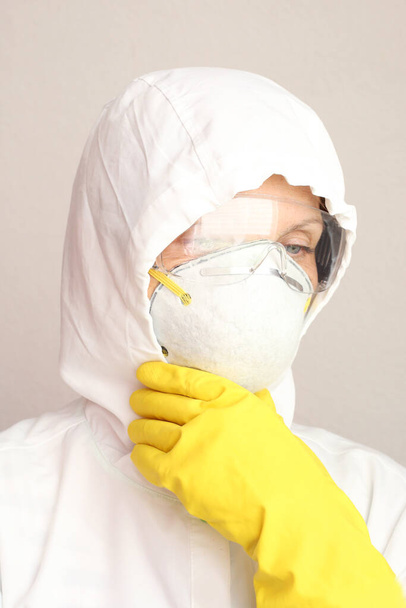 Doctor wearing protective uniform with face mask looking at camera. Corona virus covid 19 concept. - Fotografie, Obrázek