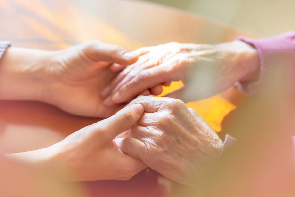 Hands of young adult and senior women. Care and elderly concept. - Foto, Imagem