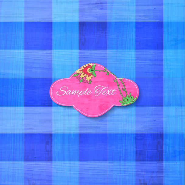 Multicolored square cloth texture background with paper floral label - Vecteur, image