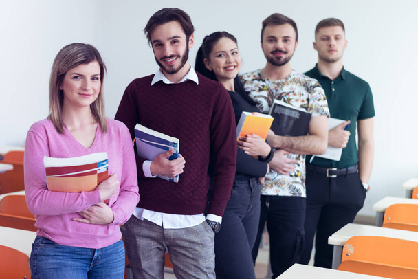 Lifestyle, education and people concept, Group of Young multiethnic university students standing inside classroom and looking at camera. - Photo, image