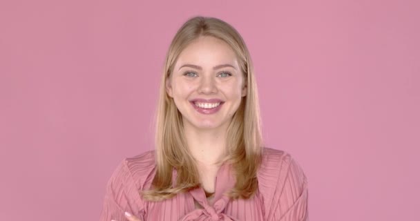 Portrait of young blonde positive female with cheerful expression, dressed in casual blouse - Felvétel, videó