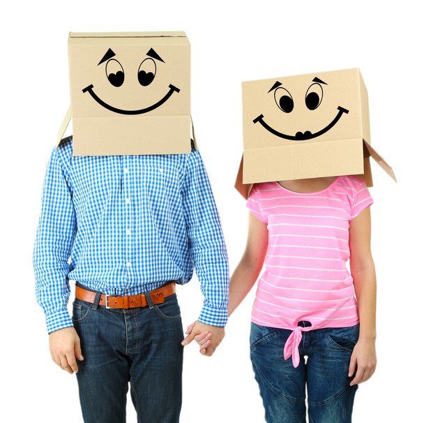 Couple with cardboard boxes on their heads isolated on white - Photo, Image