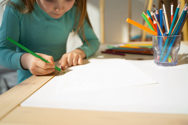 Little girl drawing on piece of paper at home - Foto, Imagem