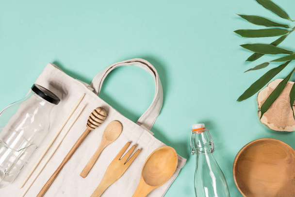 Zero waste concept. Set of environmentally friendly wooden kitchen appliances. Textile eco bags, glass jars and bamboo. Sustainable lifestyle. Plastic free concept. - Photo, Image