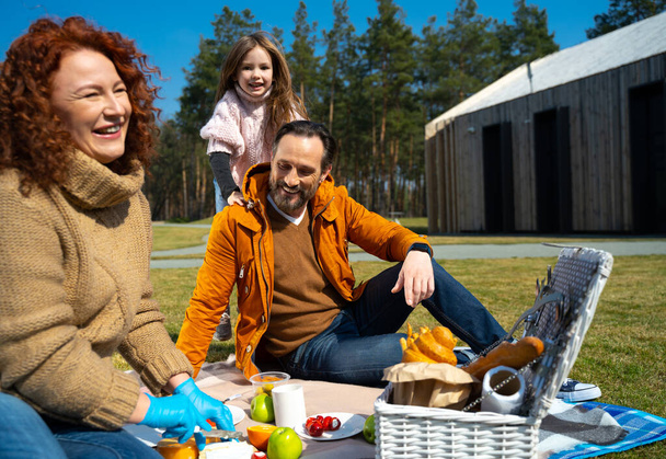 Joyful happy family having picnic outside the city - Photo, Image