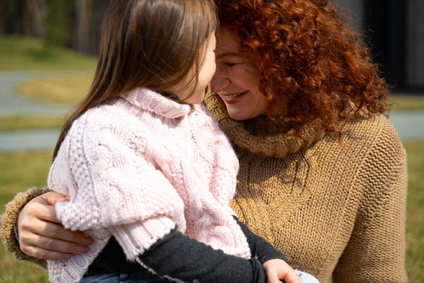 Loving mother and adorable daughter touching foreheads - Foto, Bild