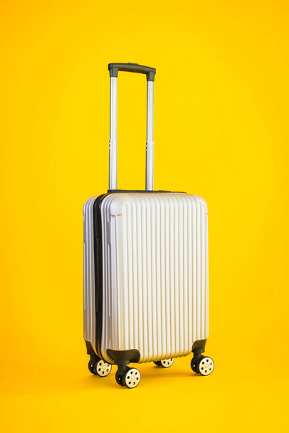 Gray color luggage or baggage bag use for transportation travel and leisure on yellow isolated background - Photo, Image