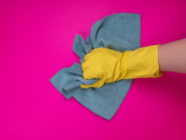 Employee hand in rubber protective glove with micro fiber cloth. Maid or housewife cares about house. general or regular clean up. Commercial cleaning company concept. disinfection products. Sanitizer - Photo, Image