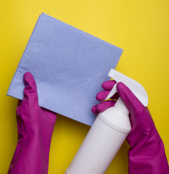 Cleaning spray bottle on yellow napkin over pink background. Flat lay, top view. Cleaning services concept. Cleaning supplies - Fotografie, Obrázek