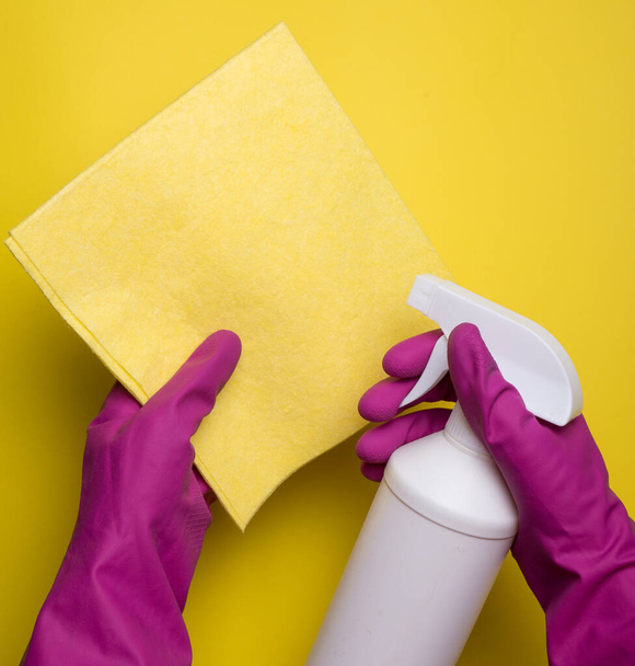 Garrafa spray de limpeza em guardanapo amarelo sobre fundo rosa. Flat lay, vista superior. Conceito de serviços de limpeza. Limpeza de suprimentos - Foto, Imagem