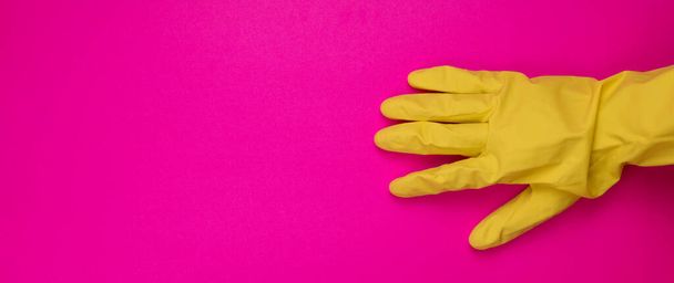 color rubber gloves for cleaning on color background, workhouse concept.  General or regular cleanup. yellow rubber gloves on background . Cleaning service - Photo, Image