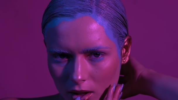 Beauty with cosmic makeup looks right into camera - Filmati, video