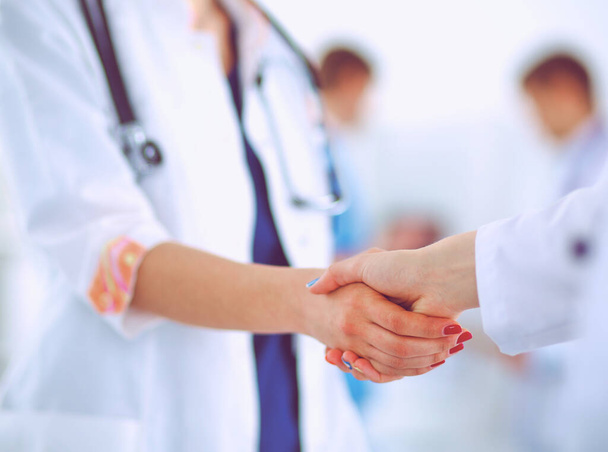 Young medical people handshaking at office - Foto, imagen