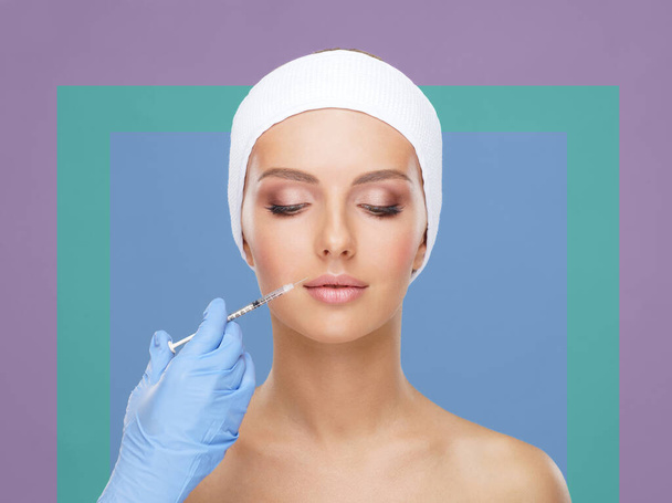 Doctor injecting in a beautiful face of a young woman. Plastic surgery, skin lifting and aesthetic medicine concept. - Foto, Imagem