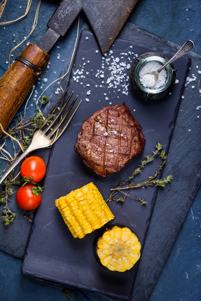 Grilled beef steak with spices and garnish. Close up, selective focus. - 写真・画像