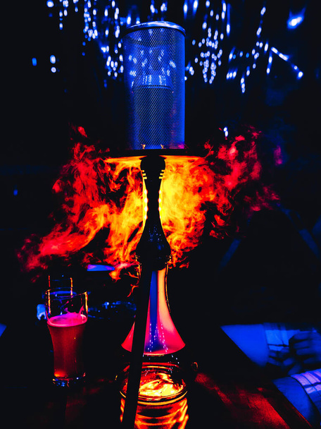 Bright art shot of hookah in orange and blue lights, with clouds of thick smoke - Photo, Image