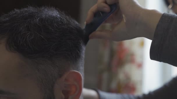A barber cuts a guy at home at the invitation of a pandemic coronavirus during quarantine. Hairdresser concept. Prores 422 - Кадри, відео