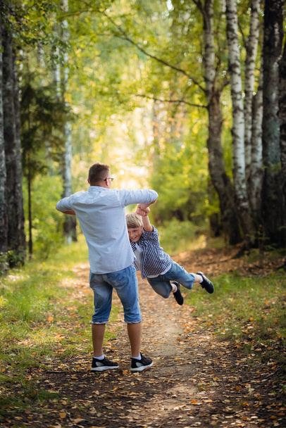 A Father and son in forest on a meadow - Valokuva, kuva