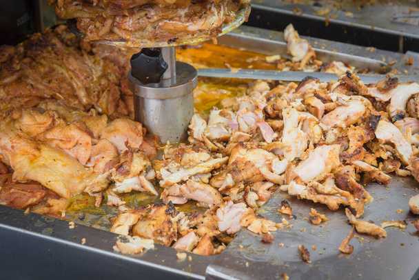 Pile of slices doner kebab meat being thin shavings from a rotating rotisserie spin in Singapore - Photo, Image