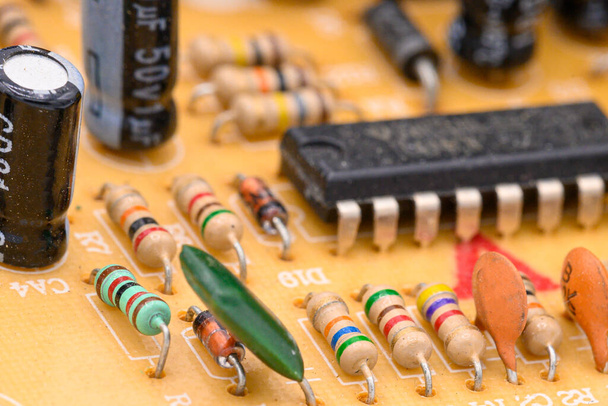 Old vintage printed circuit board with electronic components. Closeup with shallow DOF. - Photo, Image