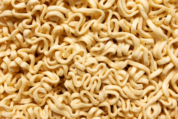 Macro instant raw noodle. Close-up uncooked ramen texture. Food background, top view - Photo, Image
