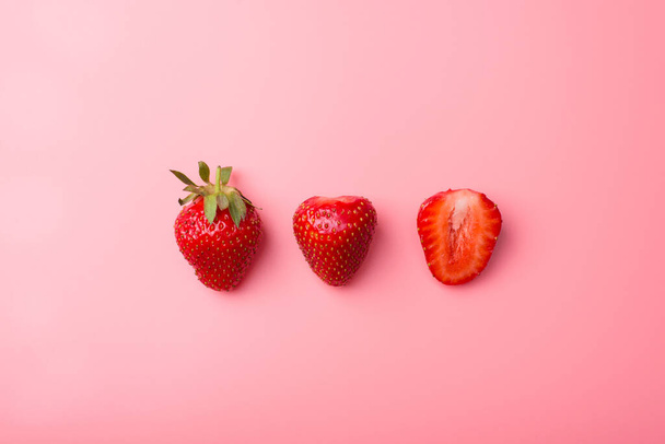 Top above overhead view photo of cut strawberries isolated on pink background - Fotó, kép