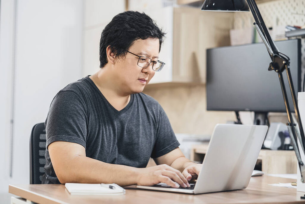 Asian business man using technology laptop for working from home , house by video conference call, startups and business owner,lifestyle occupation,social distancing concept - Photo, Image